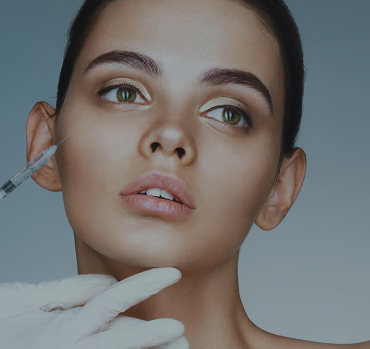 a woman applying facial botox in her face in bogota colombia